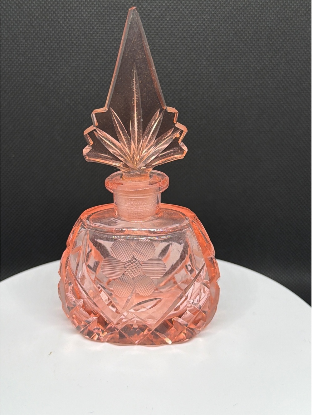 Pink glass perfume bottle with pointed stopper